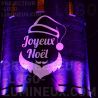 Projection lumineuse Joyeux Noël sur bâtiment