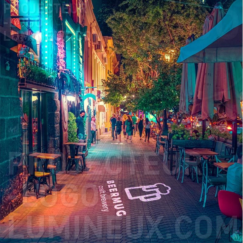 Projection logo light on the ground on sidewalk for bar and restaurant