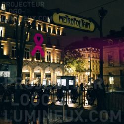 Luminous pink ribbon projection on pink October building