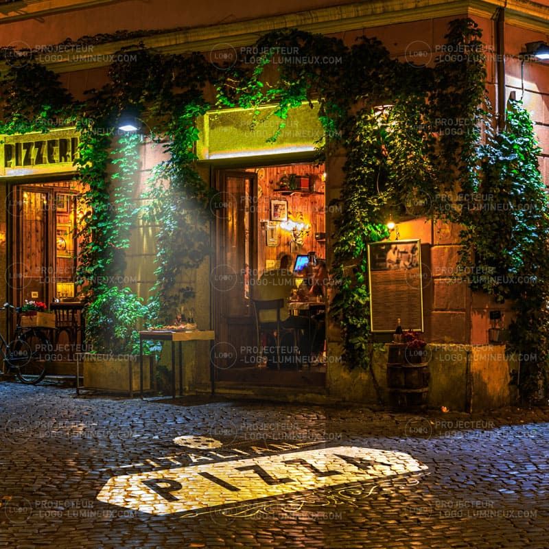 Illuminated pizzeria logo projected on the sidewalk